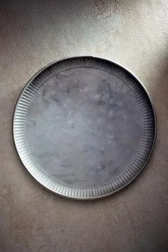 Empty metal dish on a kitchen table Stock Photos