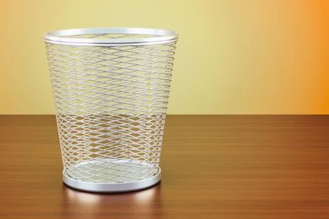 Empty metal garbage bin on the wooden table, 3D rendering Illustrazione stock