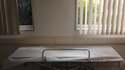 Empty metal stretcher with a white sheet in the corridor of a Japanese hospital Video stock 124772872