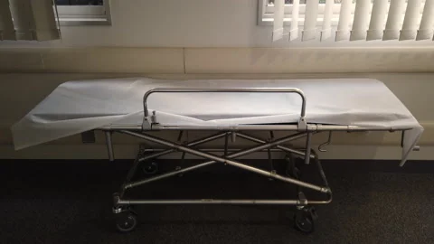 Empty metal stretcher with a white sheet in the corridor of a Japanese hospital Vídeo Stock 124773283