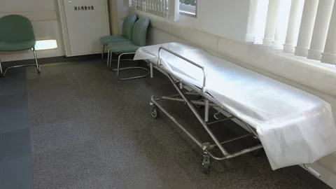 Empty metal stretcher with a white sheet in the corridor of a Japanese hospital Stock-Footage 124773560