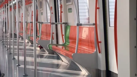 Empty Metro Train Interior with Moving Sunlight and Colorful Seats Stock Footage 331908344