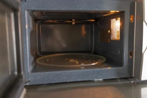 Empty microwave interior, door ajar Stock Photos