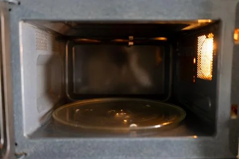 Empty microwave oven interior with rotating plate Stock Photos