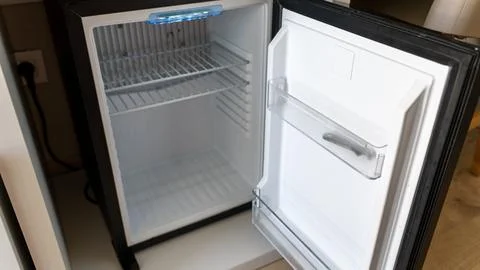 Empty Mini Refrigerator with Open Door in Hotel Room Stock Photos