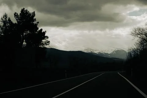 Empty misty road through winter forest. Scenic picturesque route. Sense of Stock Photos