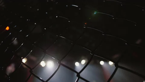 Empty mma cage arena octagon, ring for fights. Light beams, flashing spotlights Stock Footage