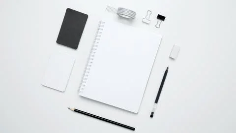 An empty mock up notebook, white and black cards, monochrome stationery items Stock Photos