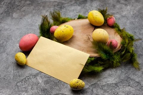 Empty mockup blank on a Easter background. Colorful eggs and feathers on th.. Stock Photos