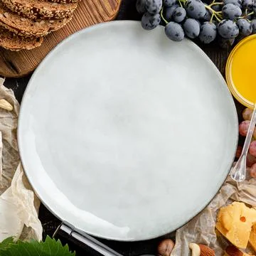 Empty mockup plate on abundance table with groceries. Mockup plate served in  Stock Photos