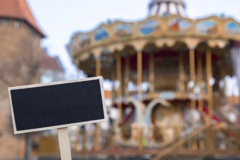 Empty mockup template Blackboard label against Carousel in amusement park. Stock Photos