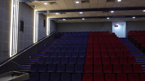 Empty Modern Auditorium with Blue and Red Seating Tiers and LED Step Lighting. Stock Footage 332143685