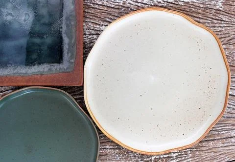 Empty modern ceramic plate on wood table background ,top view Stock Photos