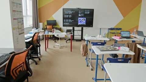 Empty Modern Classroom with Interactive Screen Displaying Code Stock Footage 342814376