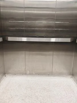 Empty modern elevator interior featuring brushed stainless steel wall panels Fotos Stock