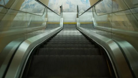 Empty modern escalator moving downward in public interior. 動画素材 346424562