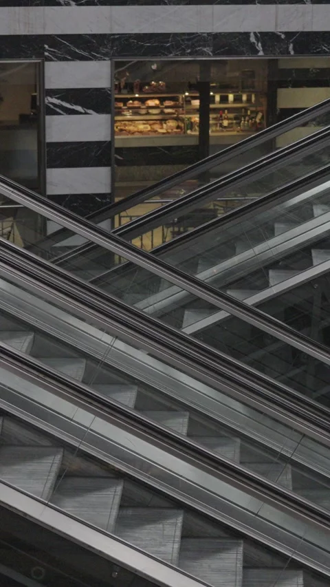 Empty modern escalators moving continuously inside a building with marble Video stock 334039833