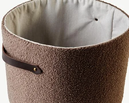 Empty modern laundry basket with leather handle showing interior lining Photos