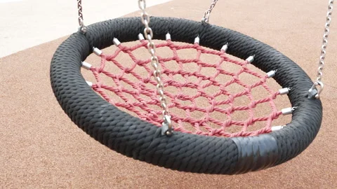Empty modern nest swing with a heavy black woven rope border on a playground. Stock Footage 346408160