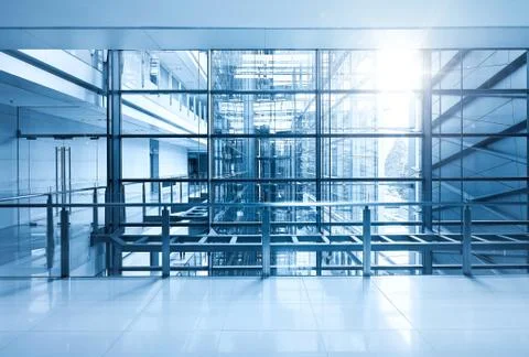 Empty modern office building interior with sunlight . Blue toned . Stock Photos