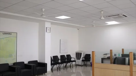 Empty Modern Office Interior with Cubicles Computer Desks and Ceiling Fans Stock Footage 334592854