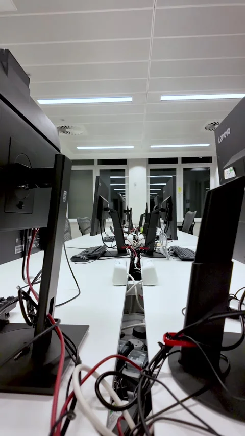An empty modern office interior features computer monitors cables wires white Stock Footage 325838549