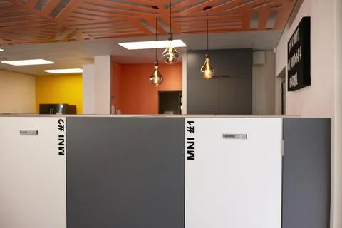 Empty modern office space with row of private cubicles and offices Stock Photos