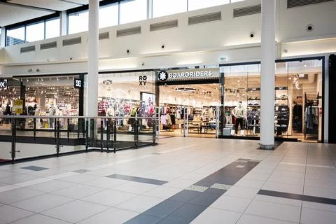 Empty modern shopping mall corridor with Boardriders store, clothing displa.. Stock Photos