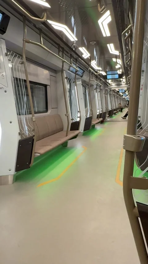Empty modern subway train interior with beige seating and green lighting ac.. Stock Footage 319037708