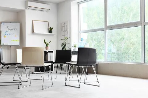 Empty modern support group meeting room with chairs Stock Photos