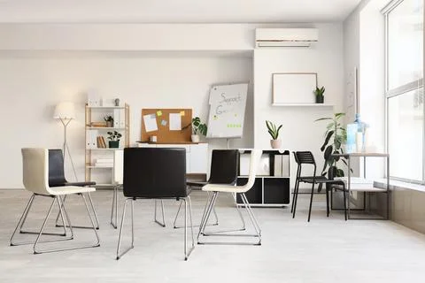 Empty modern support group meeting room with chairs in circle Stock Photos