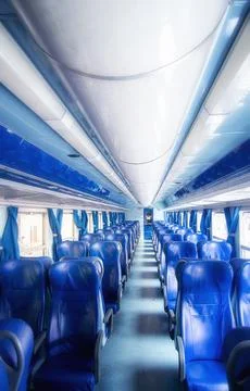 Empty modern train interior with blue leather seats Stock Photos