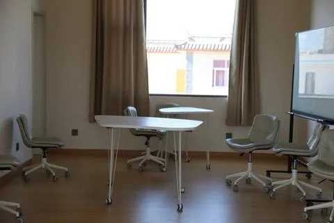 Empty modern training room with white furniture and large windows Stock Photos