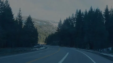 Empty mountain highway curving through evergreen forest... Stock Footage 328254651