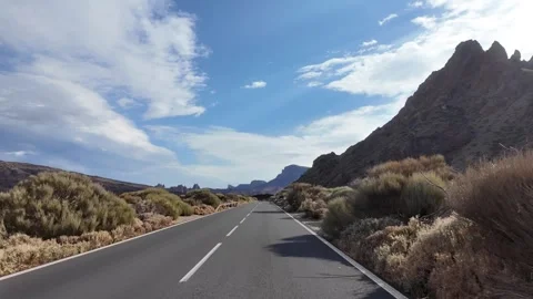 Empty mountain road through volcanic landscape under blue sky Stock-Footage 340336508
