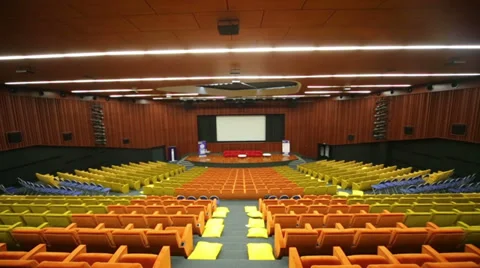 Empty movie hall with many rows of yellow and orange soft seats Stockbeeldmateriaal 38153086