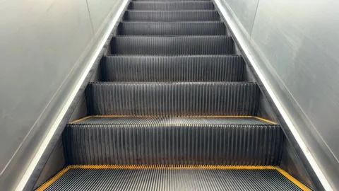Empty Moving Escalator Steps in Symmetrical Upward View Stock Footage 348574362