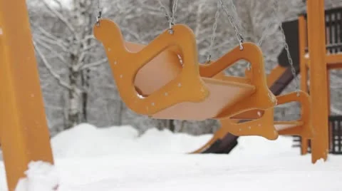 Empty moving swings on playground Stock Footage 12252040