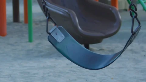 Empty moving swings at a playground Stock Footage 122183331