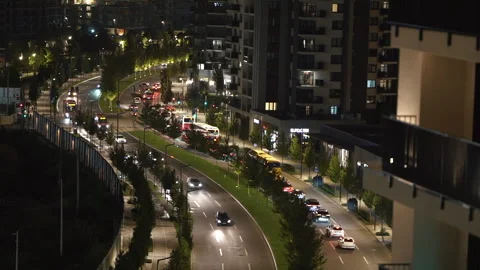 Empty multi lane road in modern city center with skyscrapers at night. Stock Footage 252372366