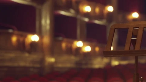 Empty music stand in theater with red seats and lights Stock Footage 342801431