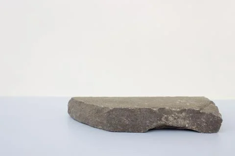 Empty natural flat gray stone podium on gray blue background. Copy space, place Stock Photos