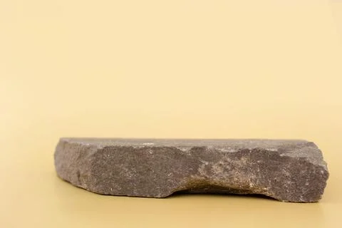 Empty natural flat gray stone podium on yellow background. Copy space, place for Stock-Fotos