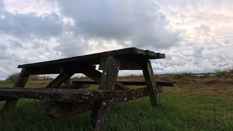 Empty nature park picnic table overlooking Welsh cloudy coastline Видео 316539957