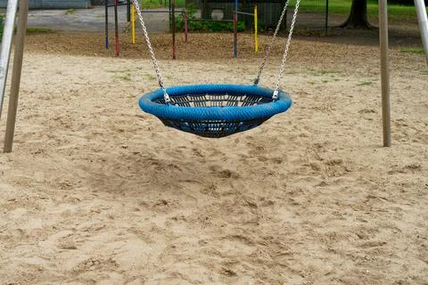 Empty nest swing at playground Stock Photos