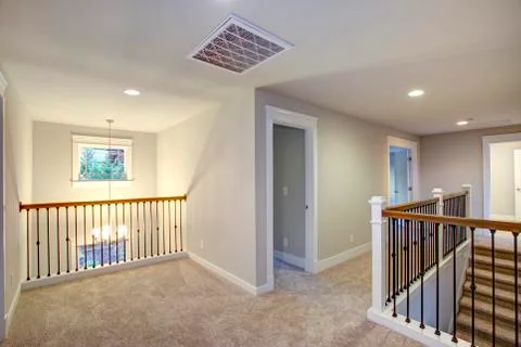 Empty New construction home interior features second floor landing with light Stock Photos