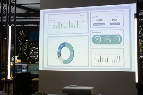 Empty night time office features modern tech displaying analytics Stock Photos