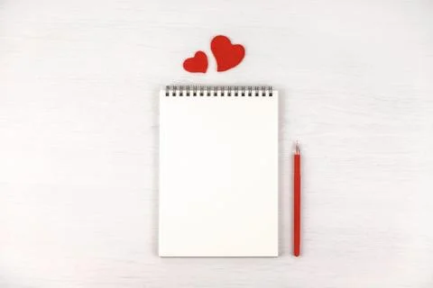 Empty note pad with felt Valentine's hearts. Stock Photos