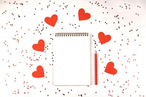 Empty note pad on festive confetti background. Stock Photos