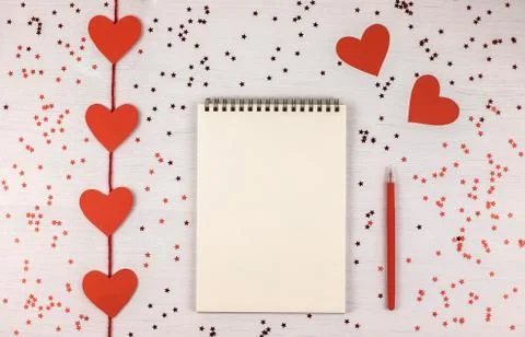 Empty note pad on festive confetti background. Stock Photos